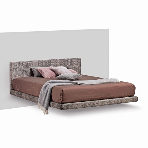 Letto Magia in tessuto con testiera, sostenuto da un unico piede, offre una sensazione di leggerezza di Lettissimi